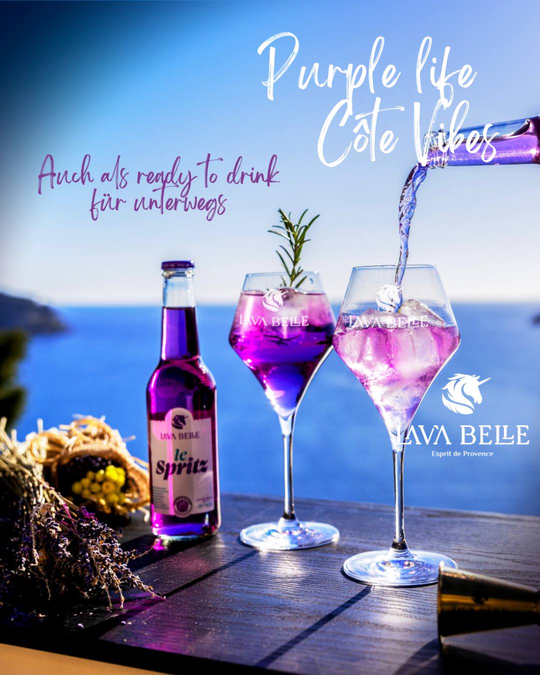 Le Spritz bottle and two glasses of purple Lav'a Belle Spritz by the sea, text: Also ready to drink for on the go
