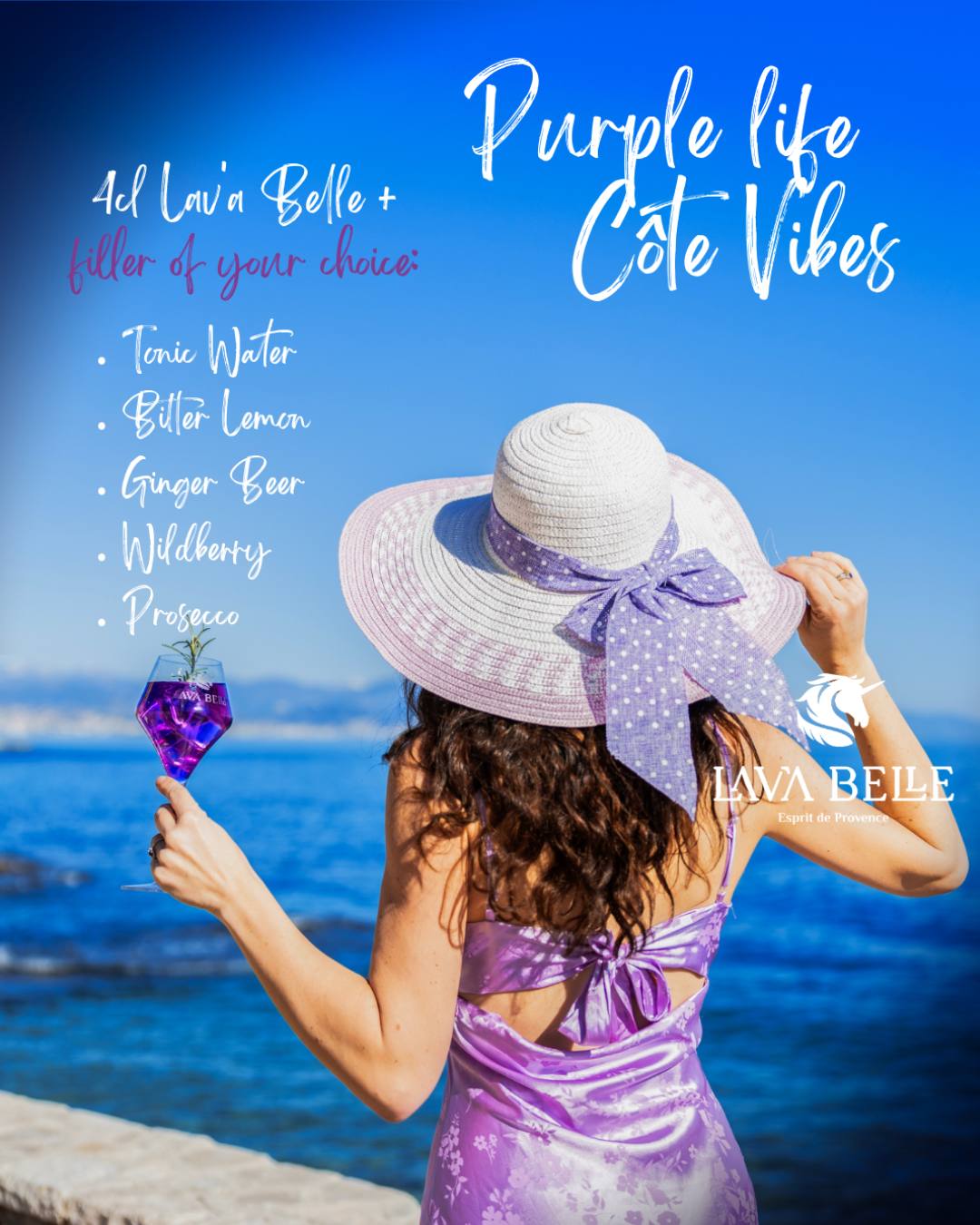 Woman in a sun hat by the sea holding a glass of purple Lav'a Belle, with mixer ideas from tonic water to prosecco